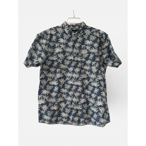 This is a Molokai Surf Co. blue and white palm tree print button-down shirt.